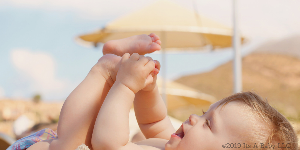 Baby on the beach with beach essentials